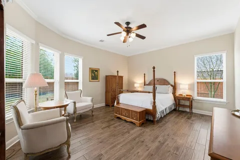 a spacious bedroom with a bed and a large window