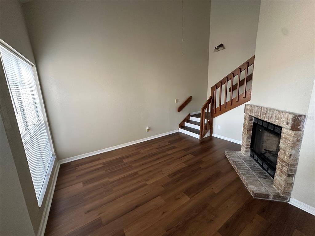 626 Cambridge Way, Unit 98 Altamonte Springs, FL 32714 - Photo 3 of 15 a view of a livingroom with wooden floor and a fireplace
