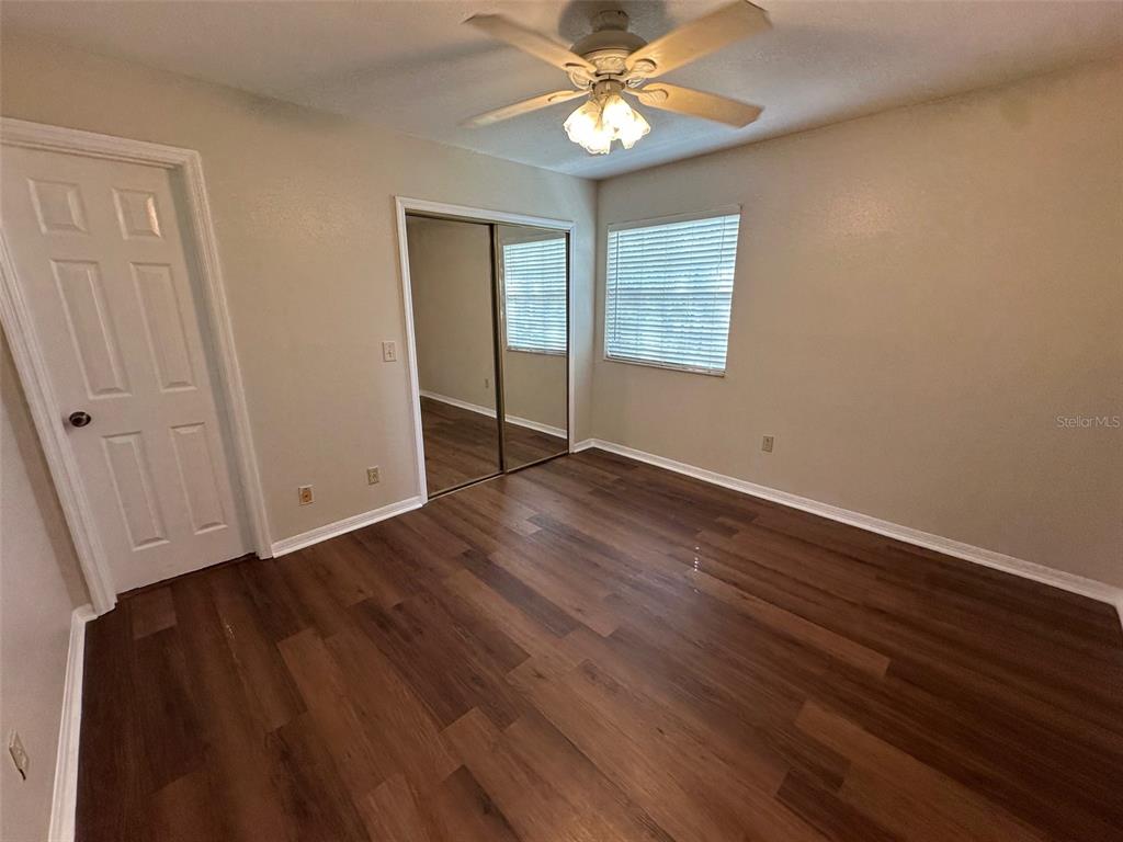 626 Cambridge Way, Unit 98 Altamonte Springs, FL 32714 - Photo 7 of 15 a view of an empty room with wooden floor and a window