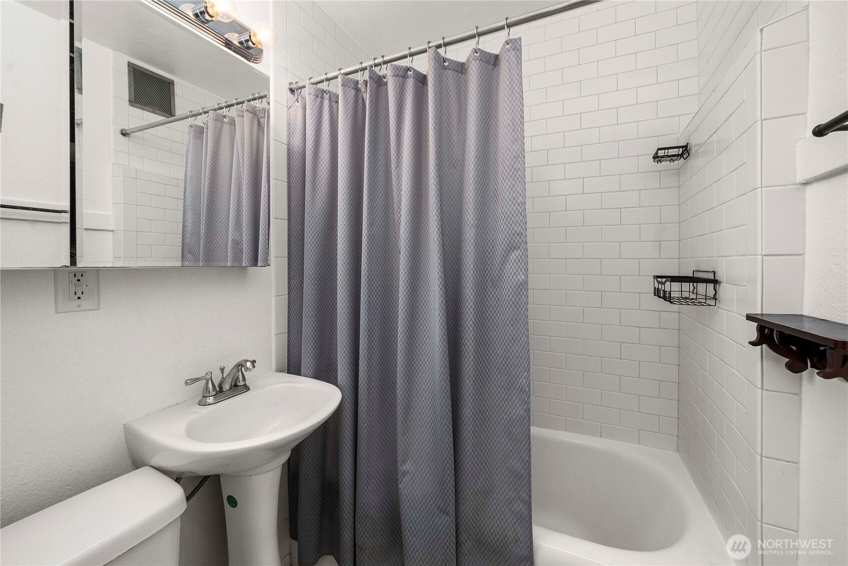905 Northeast 43rd Street, Unit 107 Seattle, WA 98105 - Photo 12 of 30 a bathroom with a sink a toilet and shower