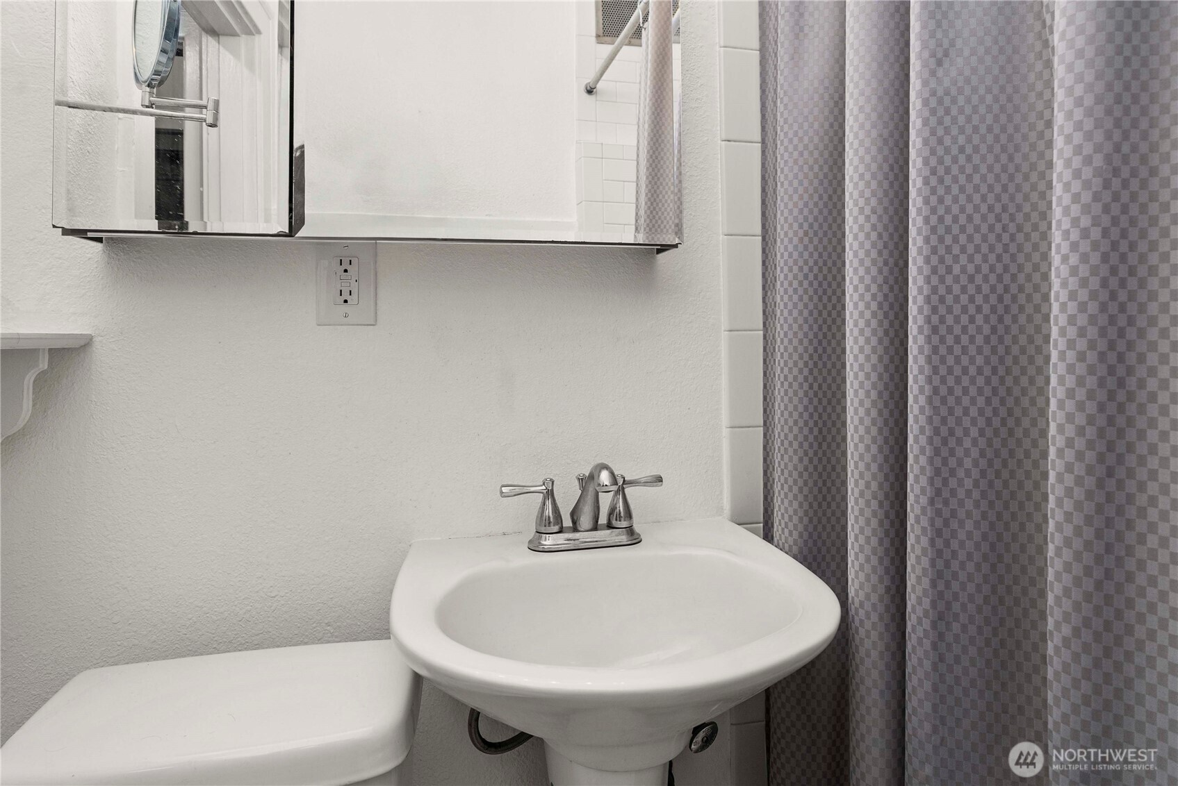 905 Northeast 43rd Street, Unit 107 Seattle, WA 98105 - Photo 13 of 30 a bathroom with a sink a toilet and mirror