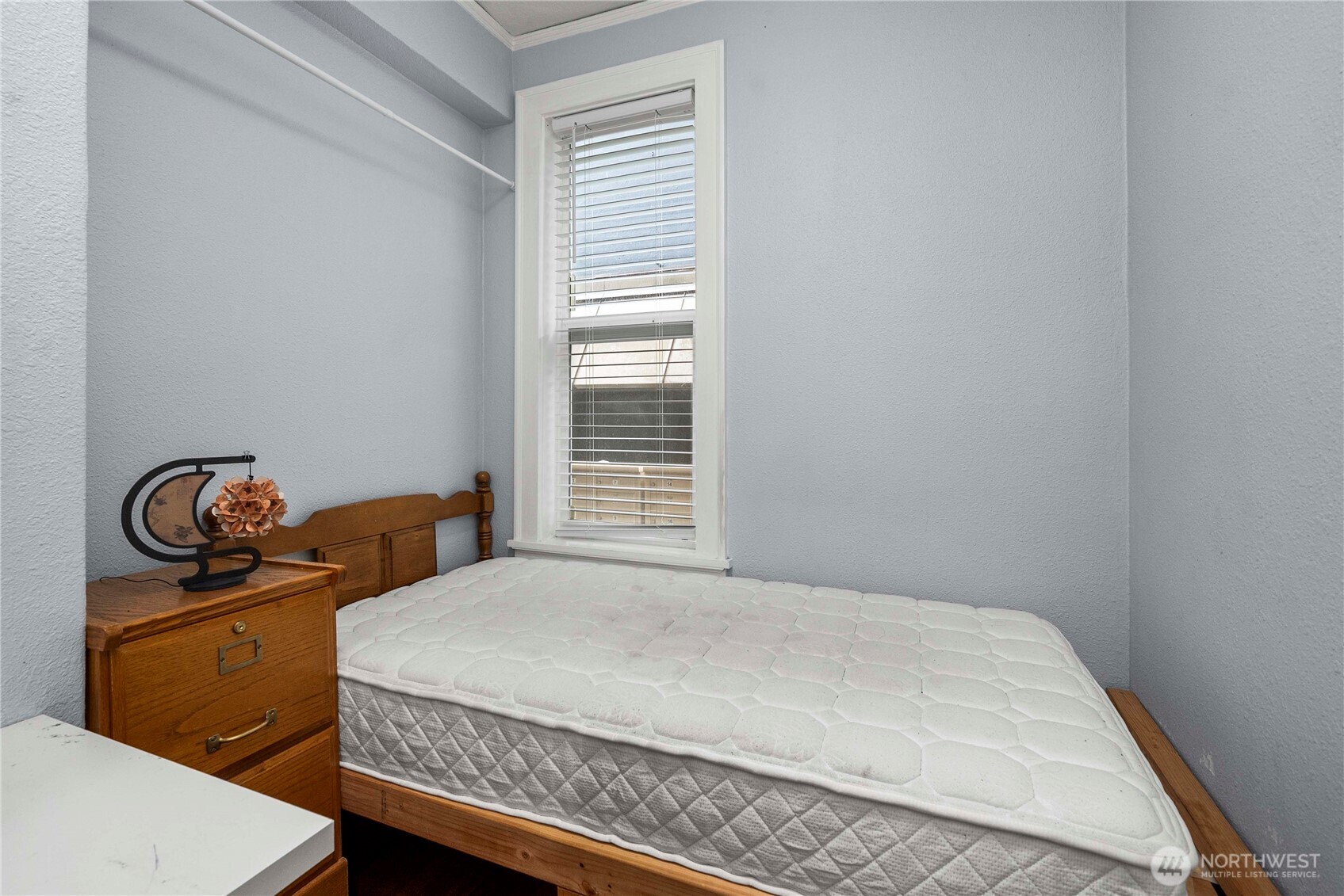 905 Northeast 43rd Street, Unit 107 Seattle, WA 98105 - Photo 18 of 30 a bedroom with a bed and wooden floor