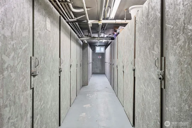 a room with stainless steel appliances a sink and a refrigerator