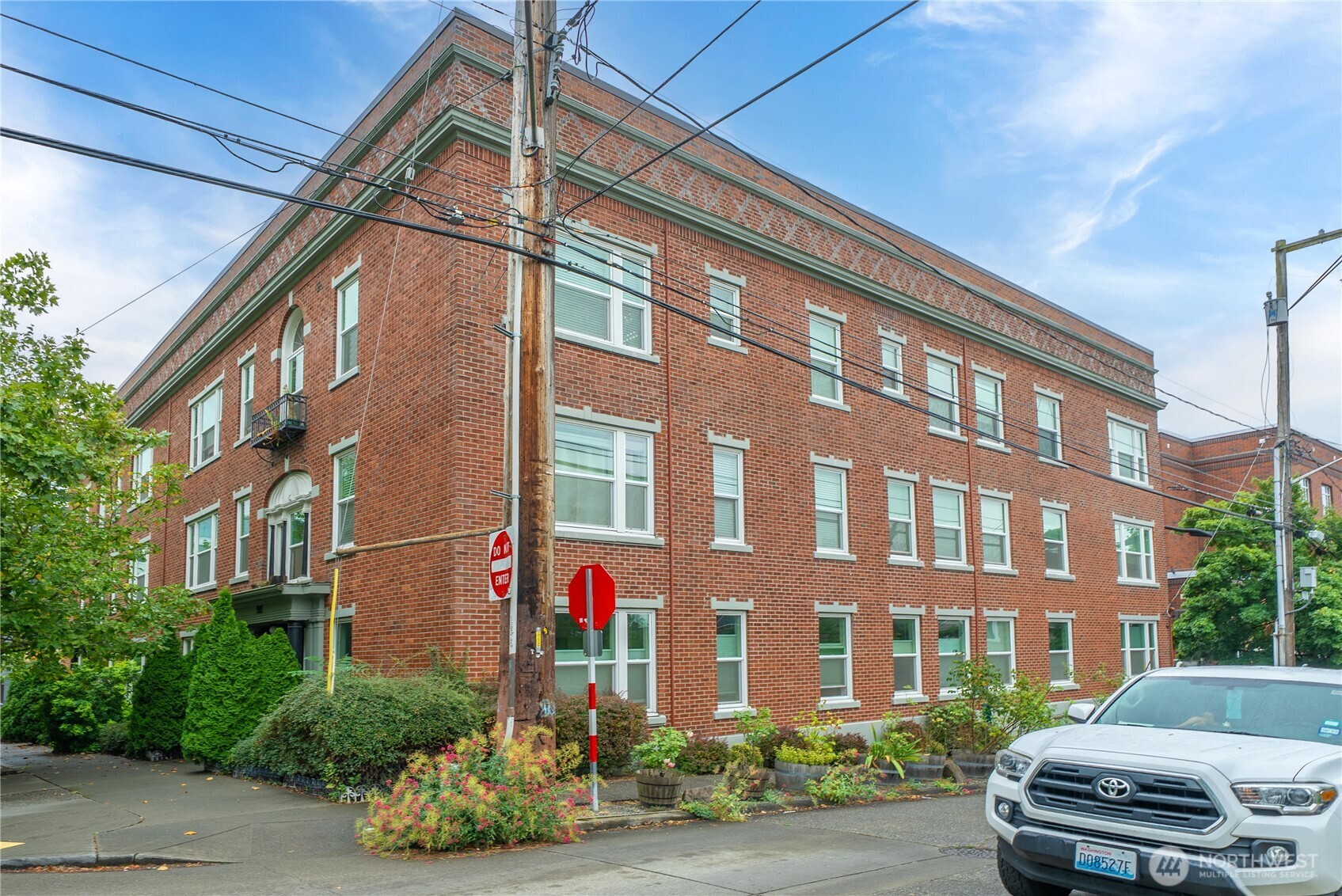 905 Northeast 43rd Street, Unit 107 Seattle, WA 98105 - Photo 28 of 30 a front view of a building and car parked