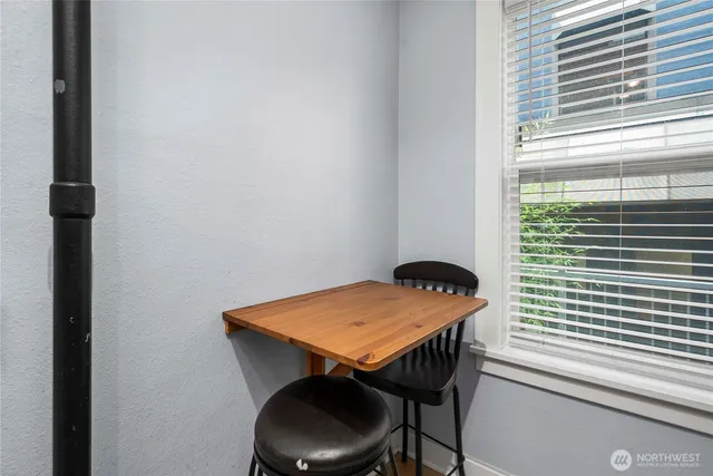 a view of a room that has a table and chair in it