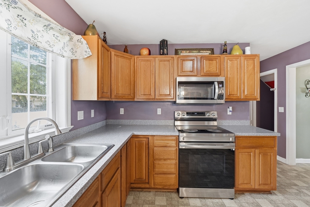 19 Annies Way Springfield, MA 01119 - Photo 11 of 40 a kitchen with granite countertop a stove and a sink