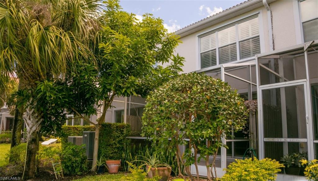 16097 Ravina Way, Unit 36 Naples, FL 34110 - Photo 15 of 19 a backyard of a house with lots of green space and fountain