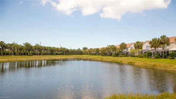 an aerial view of residential houses with outdoor space and lake view