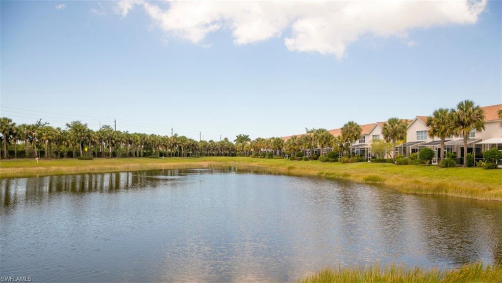 16097 Ravina Way, Unit 36 Naples, FL 34110 - Photo 16 of 19 a view of a lake with houses in the back