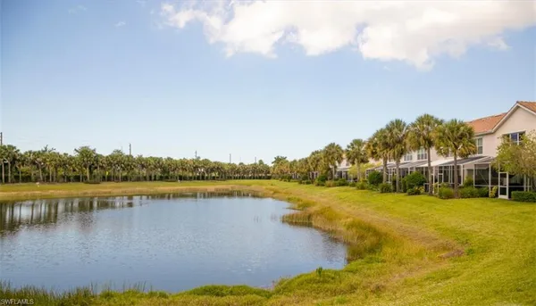 an aerial view of residential houses with outdoor space and lake view