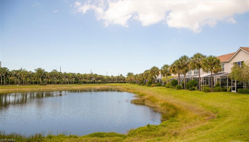 16097 Ravina Way, Unit 36 Naples, FL 34110 - Photo 17 of 19 a view of a lake with houses in the back