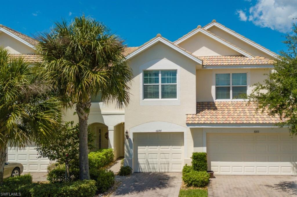 16097 Ravina Way, Unit 36 Naples, FL 34110 - Photo 2 of 19 a front view of a house with a garden