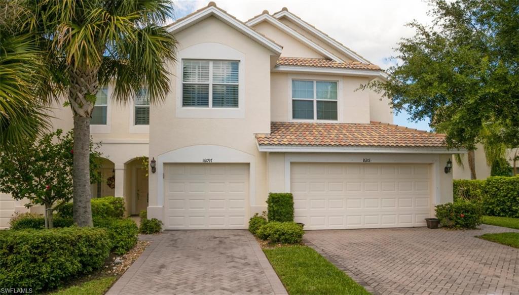 16097 Ravina Way, Unit 36 Naples, FL 34110 - Photo 3 of 19 a front view of a house with a garden