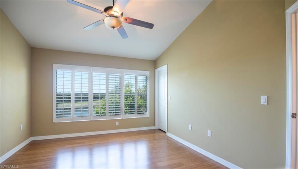 16097 Ravina Way, Unit 36 Naples, FL 34110 - Photo 6 of 19 a view of an empty room with window and wooden floor