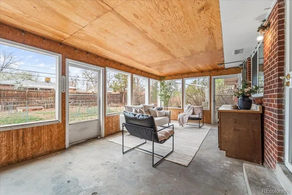 a living room with furniture and a floor to ceiling window