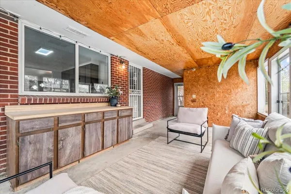 a spacious bedroom with a bed a flat screen tv and balcony