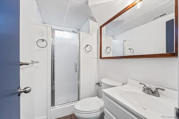 a white toilet sitting next to a bathroom sink