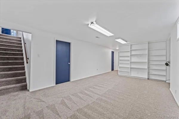 a view of an empty room with a ceiling fan