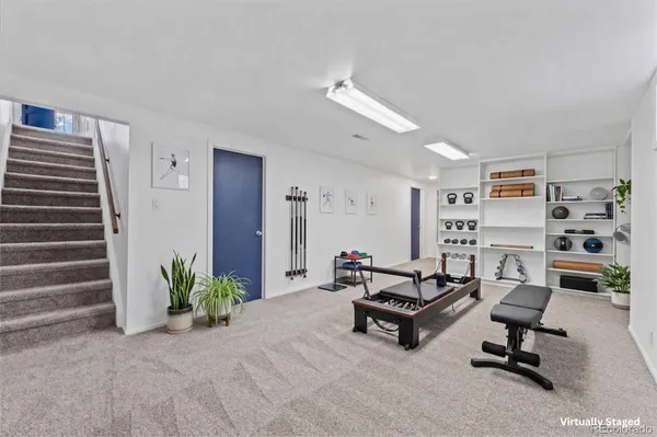 a view of a livingroom with furniture and gym equipment