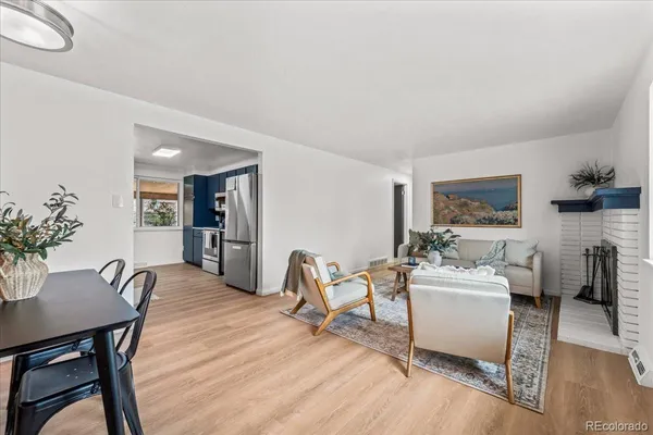 a living room with furniture dining table and wooden floor