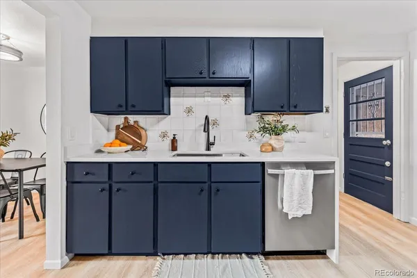 a kitchen with a sink and wooden cabinets