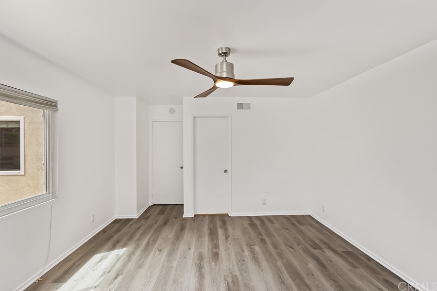20 Wildwheat Irvine, CA 92614 - Photo 19 of 29 a view of a room with wooden floor and a ceiling fan