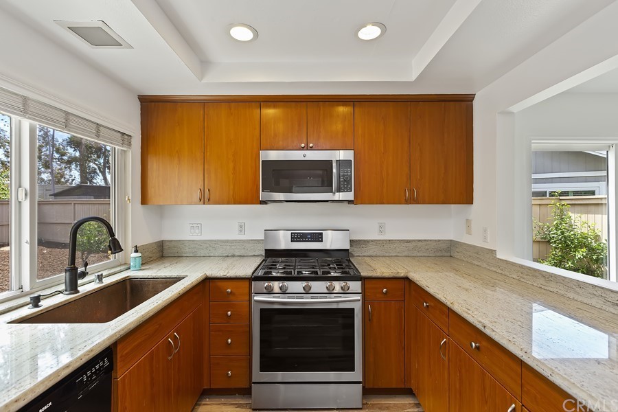 20 Wildwheat Irvine, CA 92614 - Photo 10 of 29 a kitchen with stainless steel appliances a stove sink and microwave