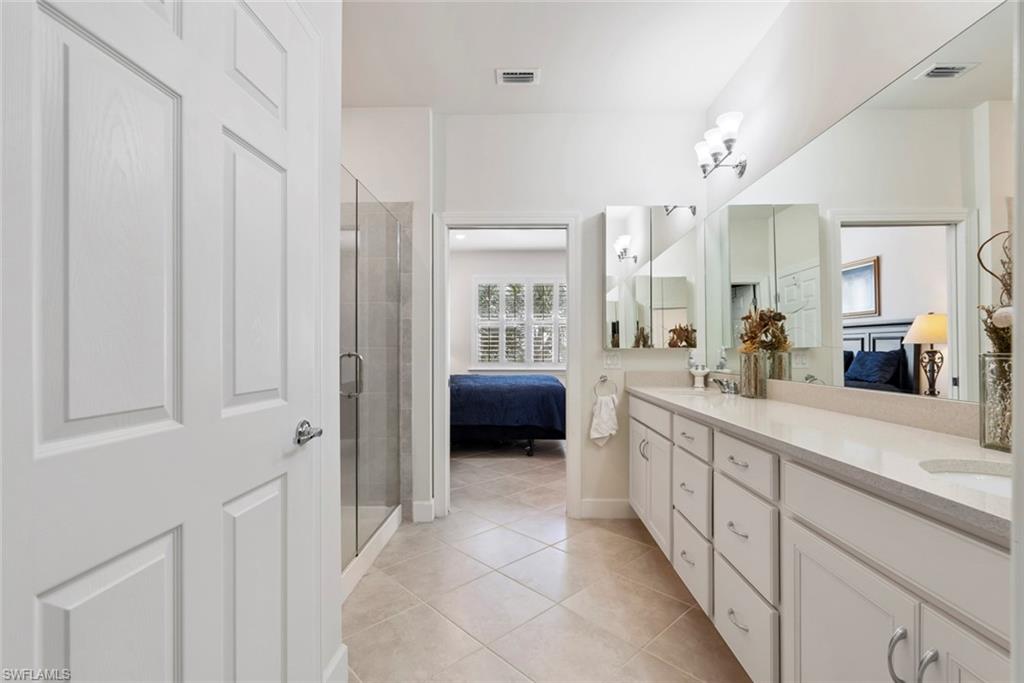 5694 Mayflower Way, Unit 505 Ave Maria, FL 34142 - Photo 16 of 43 a spacious en suite bathroom with a double vanity sink and mirror