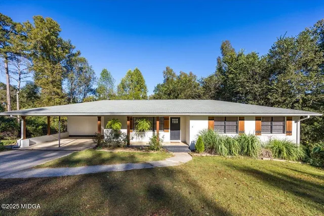 a view of house with yard and outdoor space