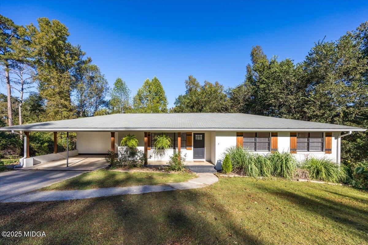 a view of house with yard and outdoor space