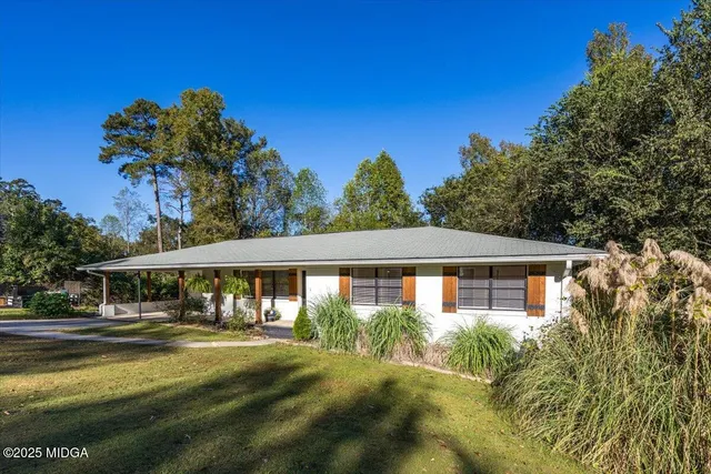 a view of a white house with a swimming pool
