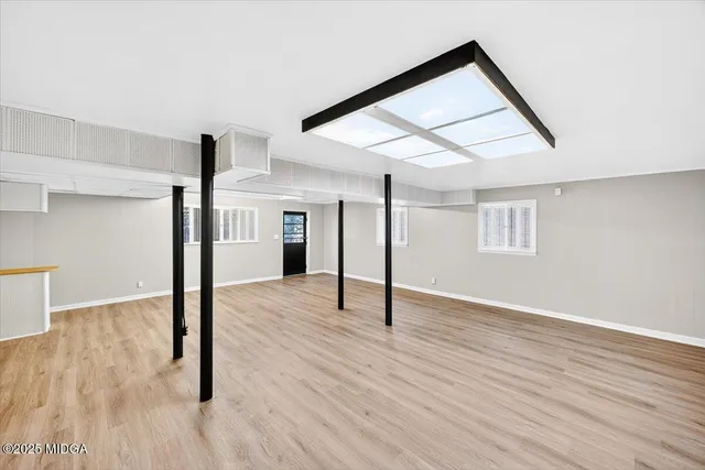 a view of empty room with wooden floor