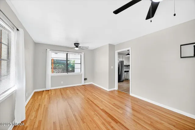 wooden floor in an empty room with a window