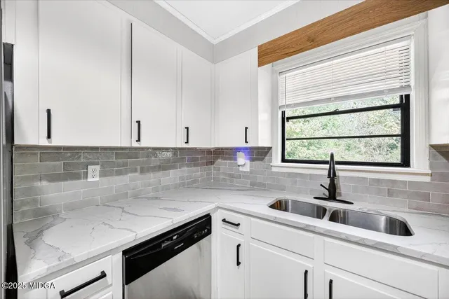 a kitchen with a sink and cabinets