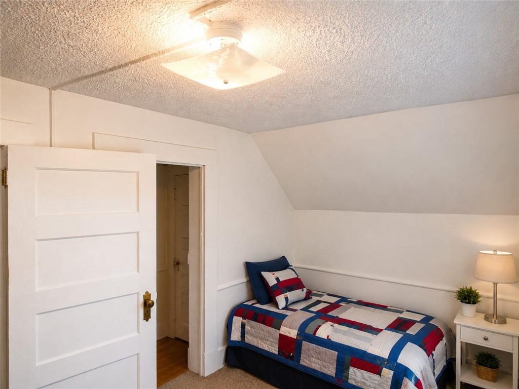 741 Center Avenue Butler, PA 16001 - Photo 13 of 27 a bedroom with a bed and a refrigerator