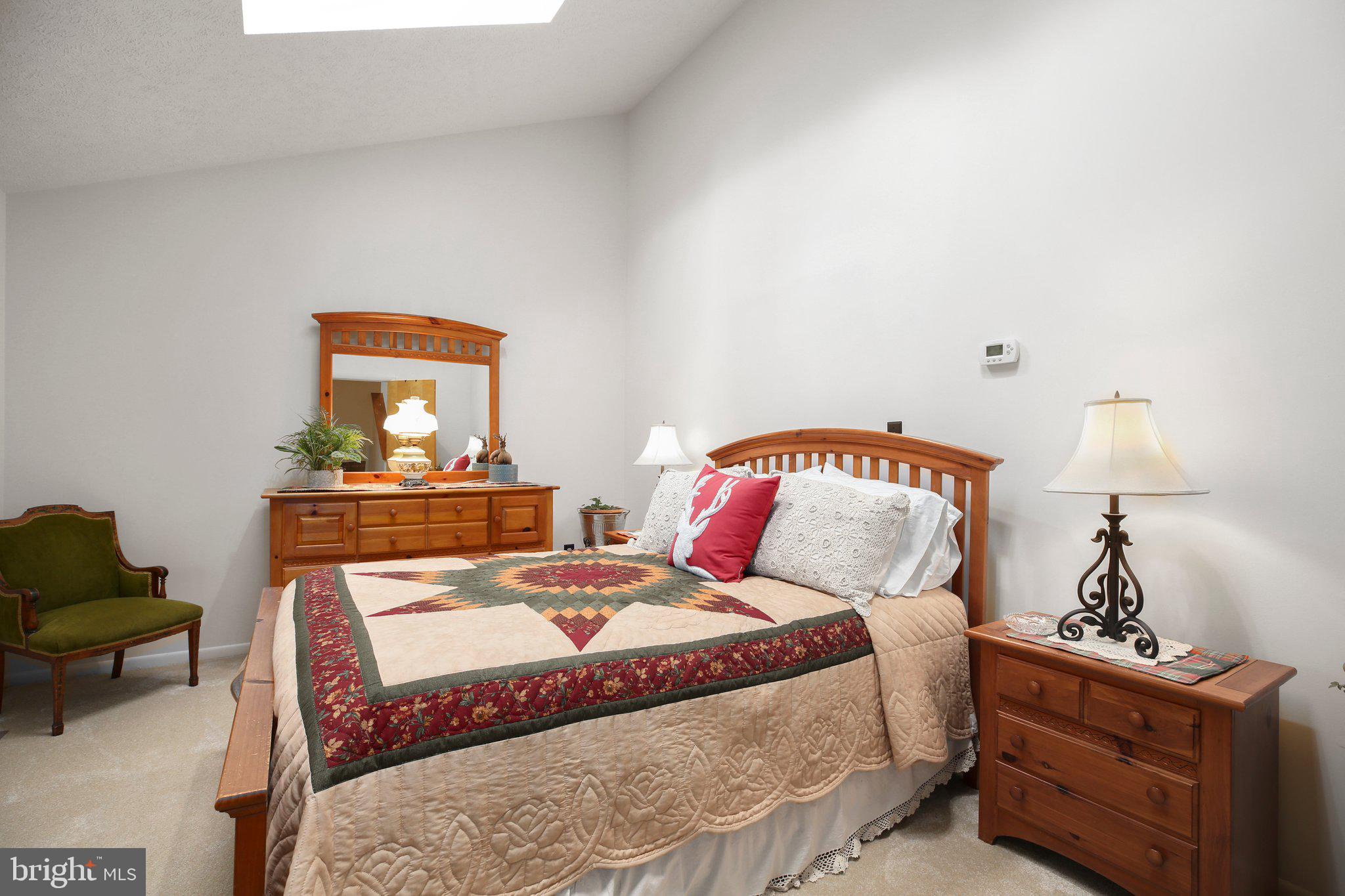 10831 Moore Drive Manassas, VA 20111 - Photo 12 of 52 a bedroom with a bed and a lamp on dresser