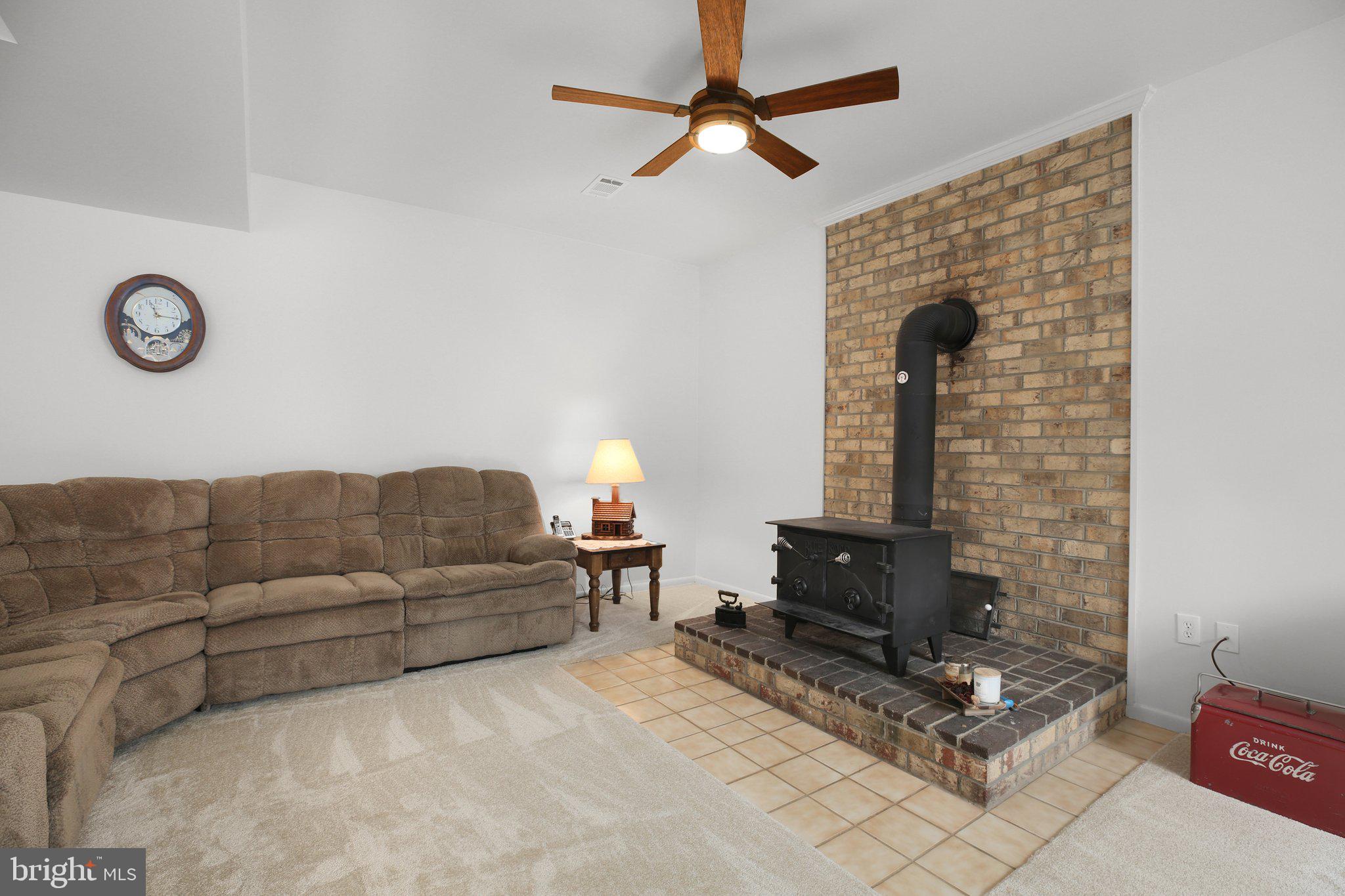 10831 Moore Drive Manassas, VA 20111 - Photo 16 of 52 a living room with furniture a rug and a fireplace