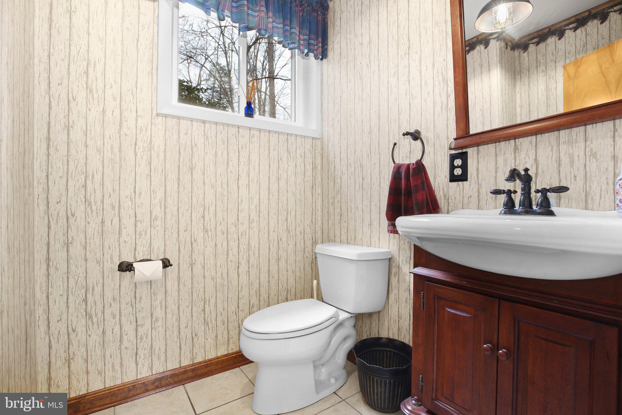 10831 Moore Drive Manassas, VA 20111 - Photo 20 of 52 a bathroom with a toilet sink and mirror