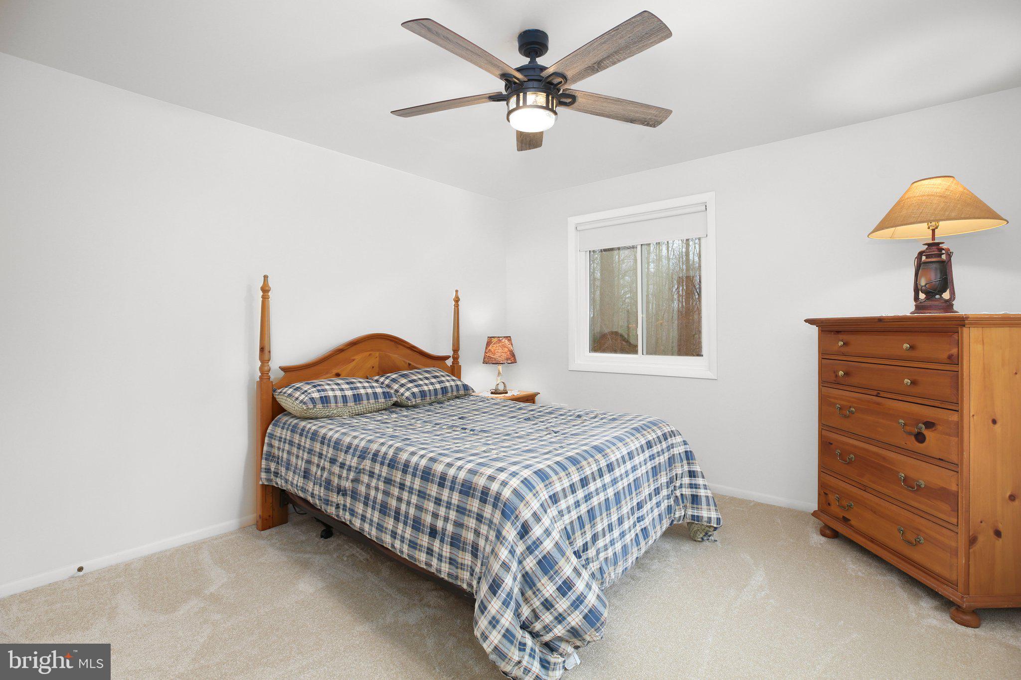 10831 Moore Drive Manassas, VA 20111 - Photo 26 of 52 a bedroom with a bed and a chandelier
