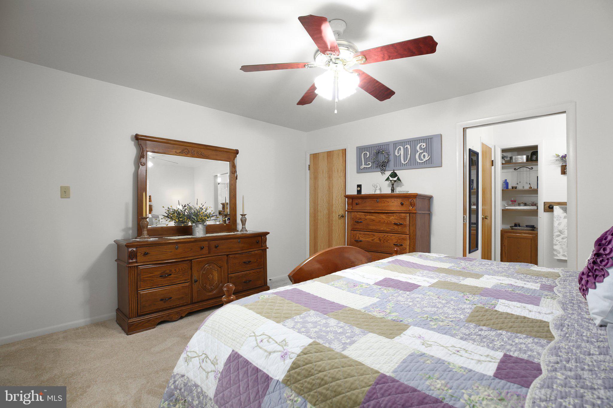 10831 Moore Drive Manassas, VA 20111 - Photo 29 of 52 a bedroom with a bed and a dresser