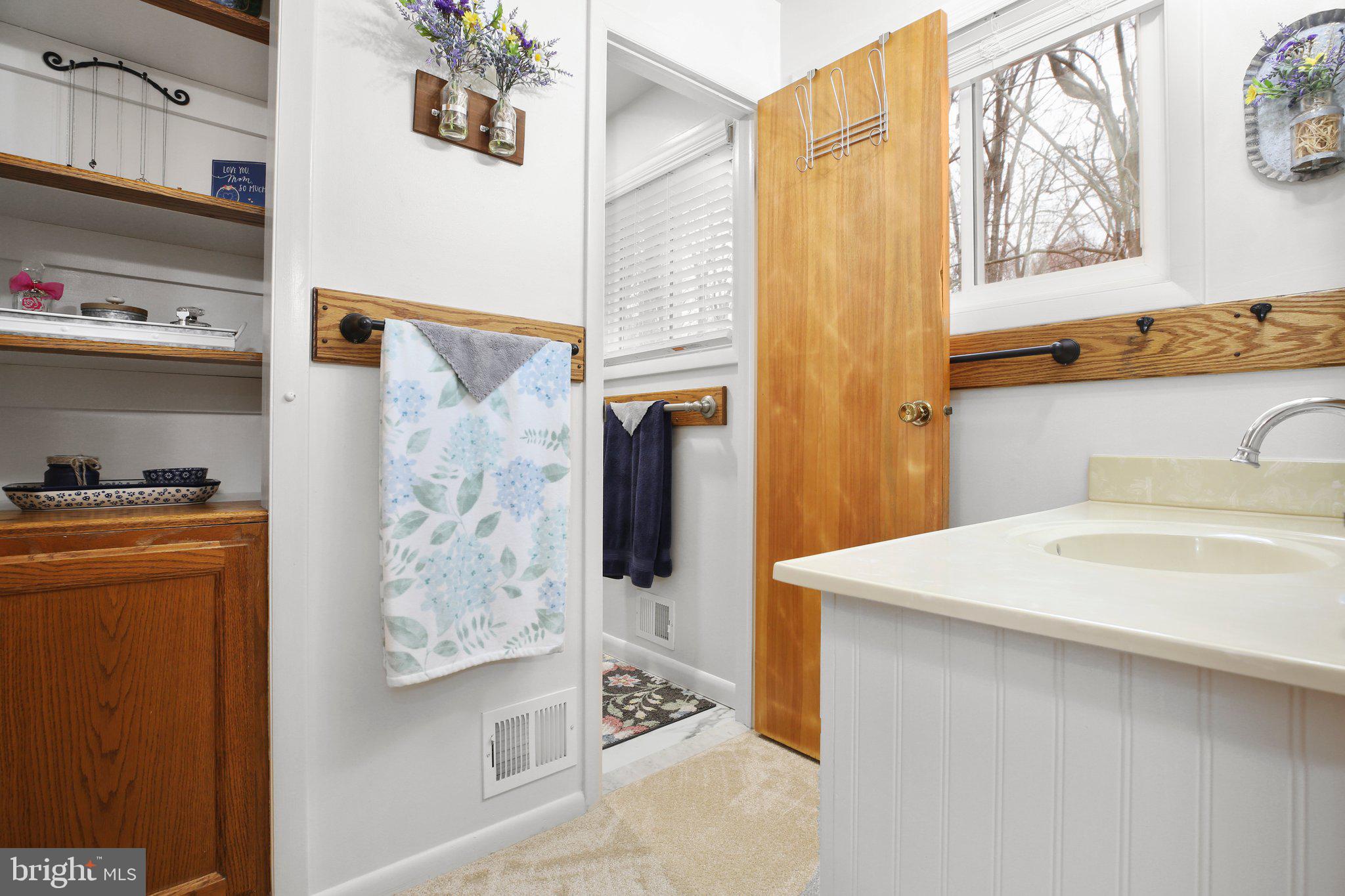 10831 Moore Drive Manassas, VA 20111 - Photo 30 of 52 a bathroom with a sink a mirror and a shower