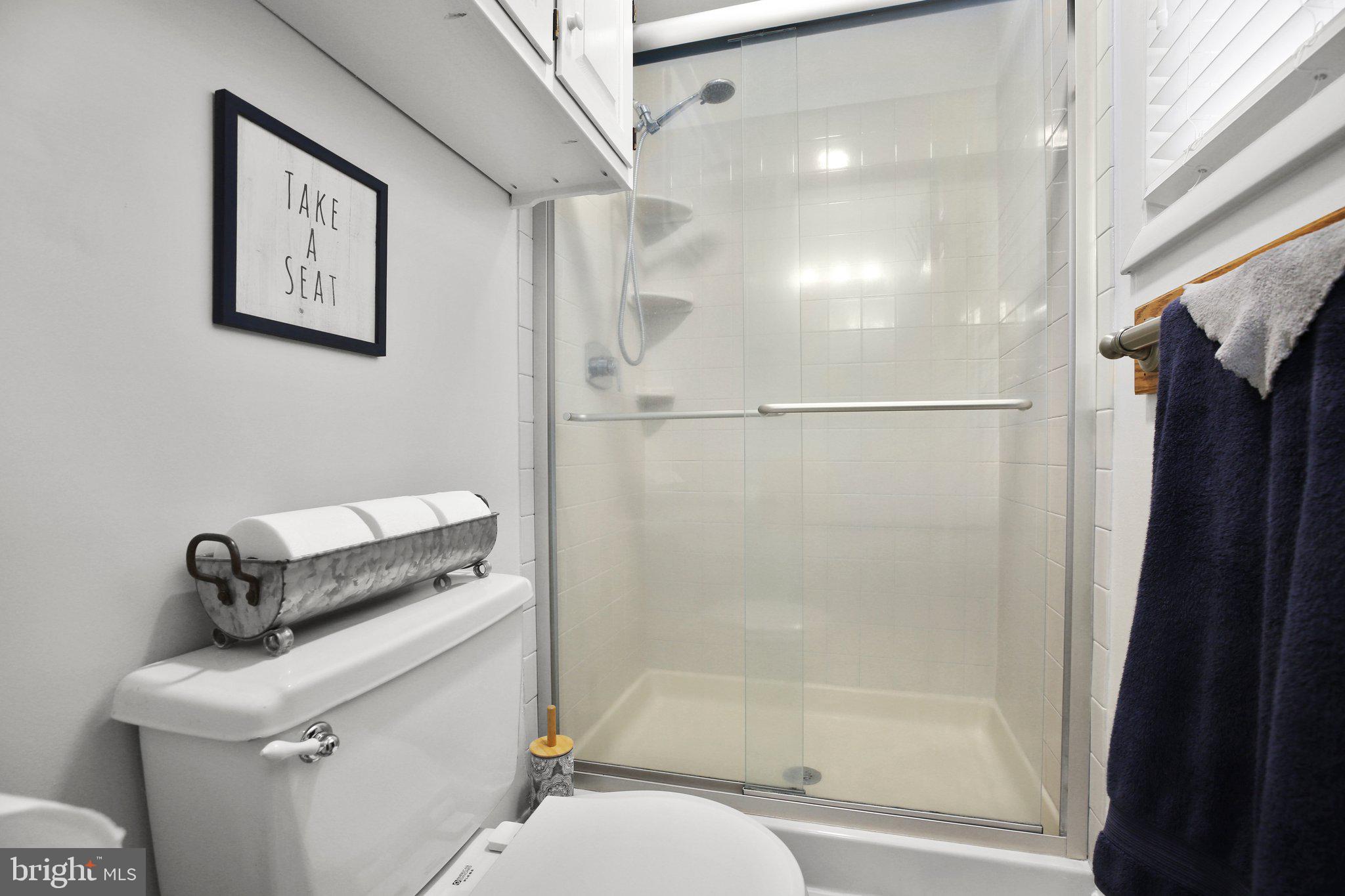 10831 Moore Drive Manassas, VA 20111 - Photo 32 of 52 a bathroom with a shower a toilet and a sink