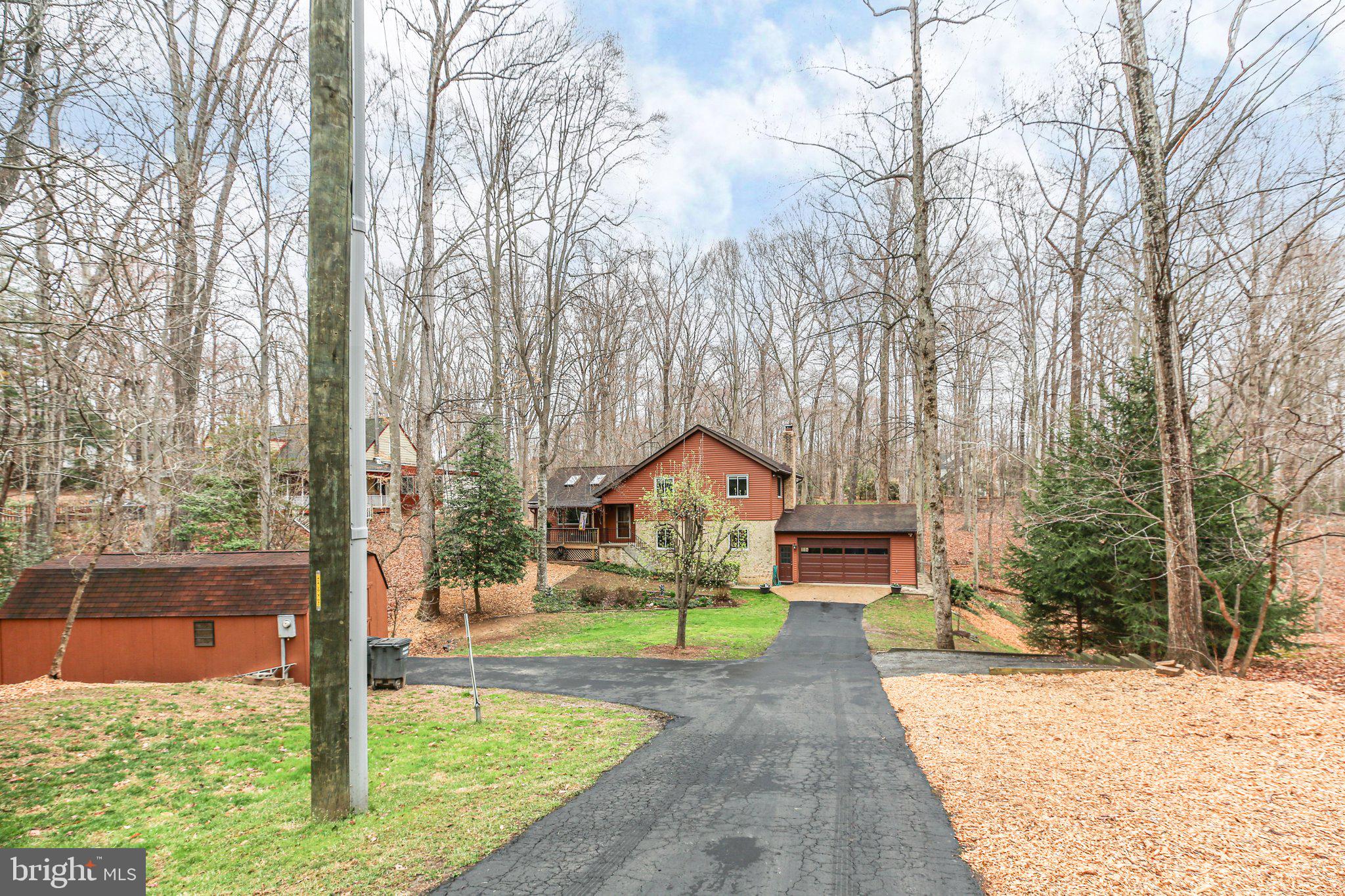 10831 Moore Drive Manassas, VA 20111 - Photo 48 of 52 a front view of a house with a yard and large tree