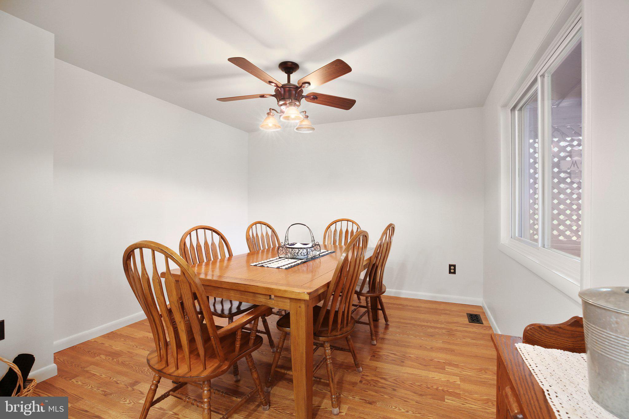 10831 Moore Drive Manassas, VA 20111 - Photo 5 of 52 a dining room with furniture and wooden floor