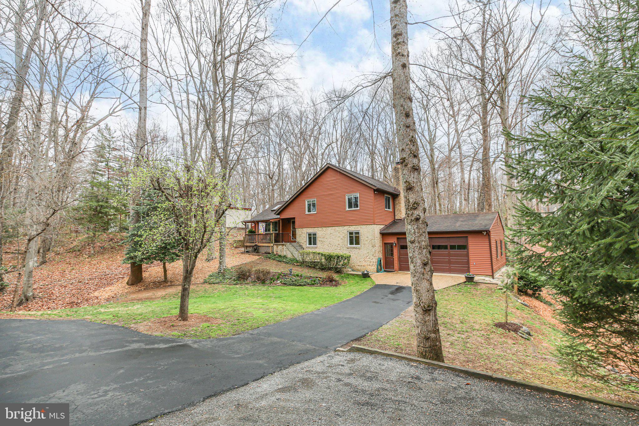 10831 Moore Drive Manassas, VA 20111 - Photo 51 of 52 a front view of a house with a yard and garage