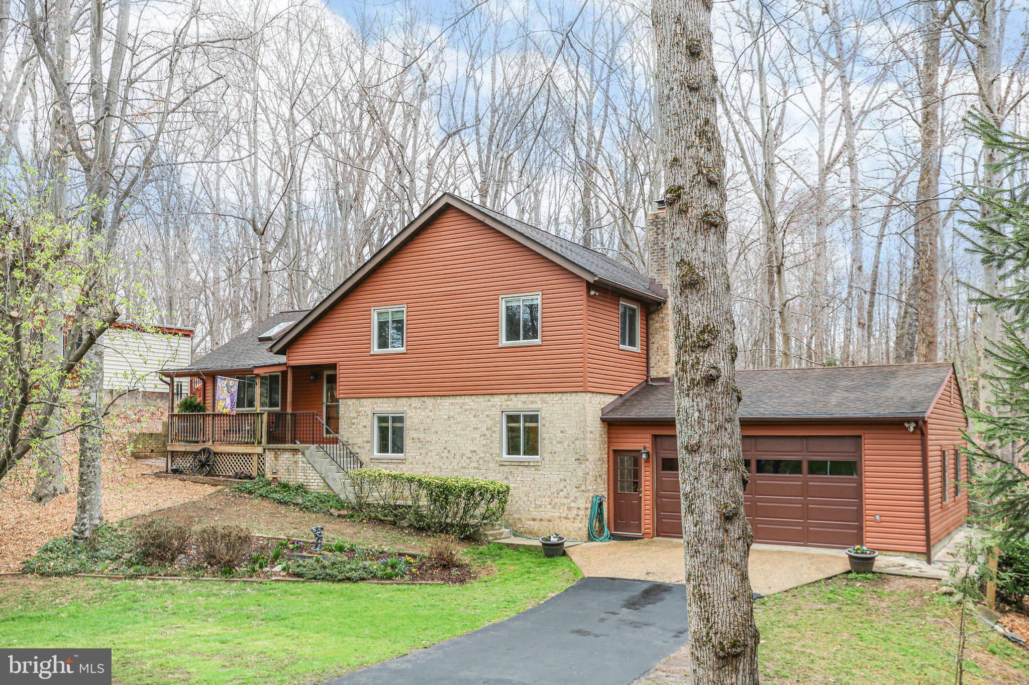 10831 Moore Drive Manassas, VA 20111 - Photo 52 of 52 a front view of a house with garden