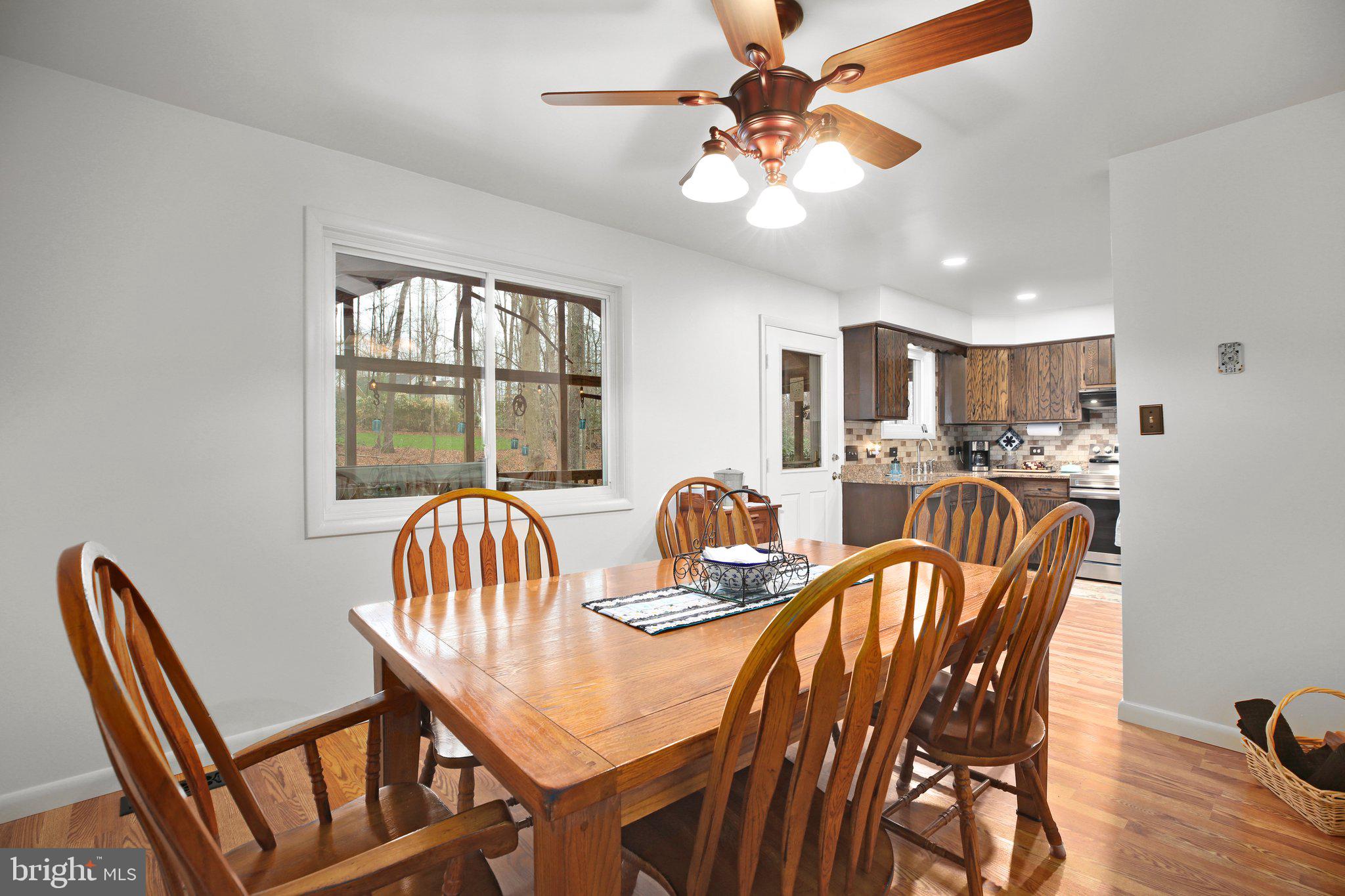 10831 Moore Drive Manassas, VA 20111 - Photo 7 of 52 a dining room with furniture a window and a chandelier