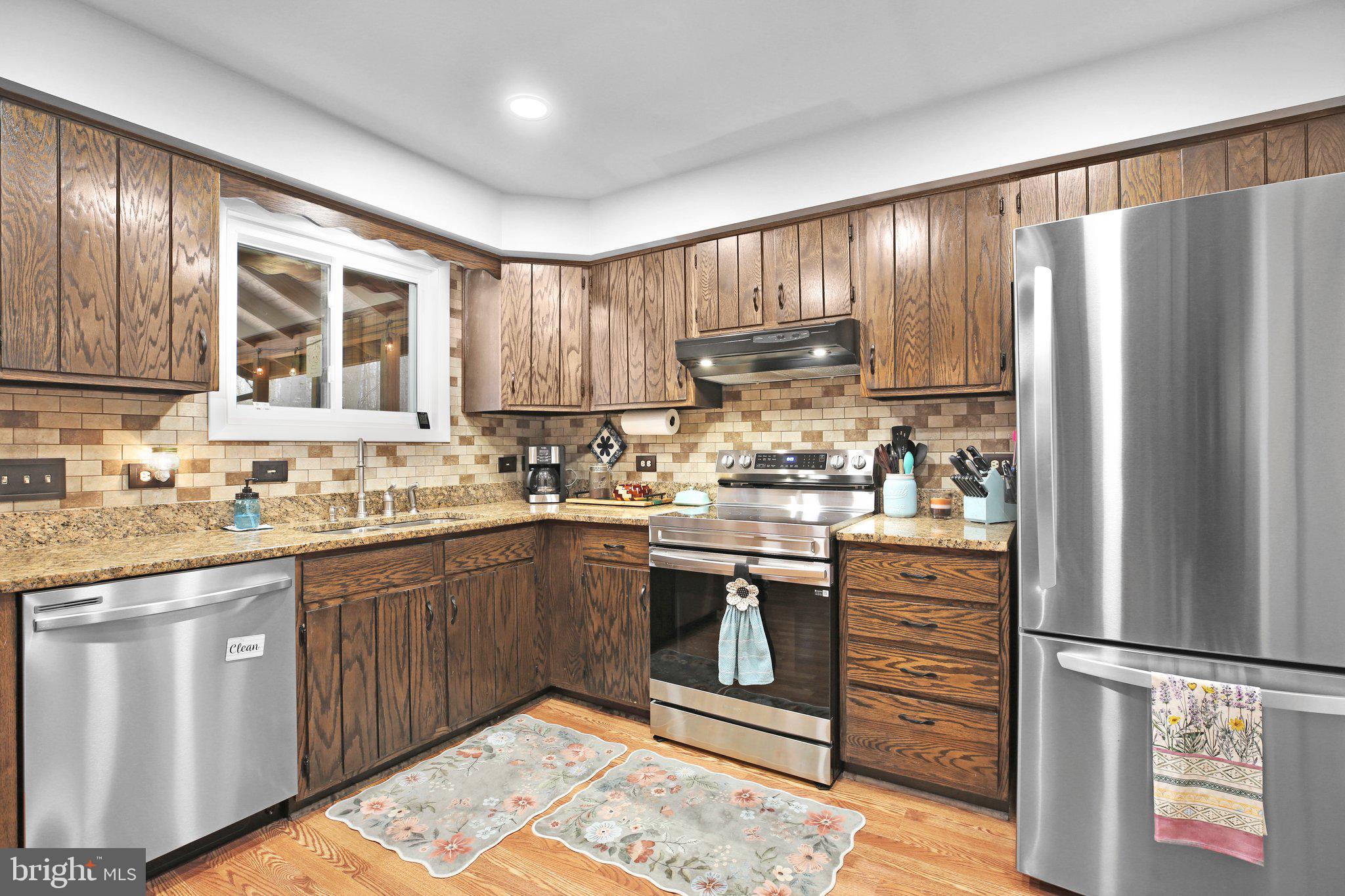 10831 Moore Drive Manassas, VA 20111 - Photo 8 of 52 a kitchen with stainless steel appliances granite countertop a refrigerator sink and cabinets