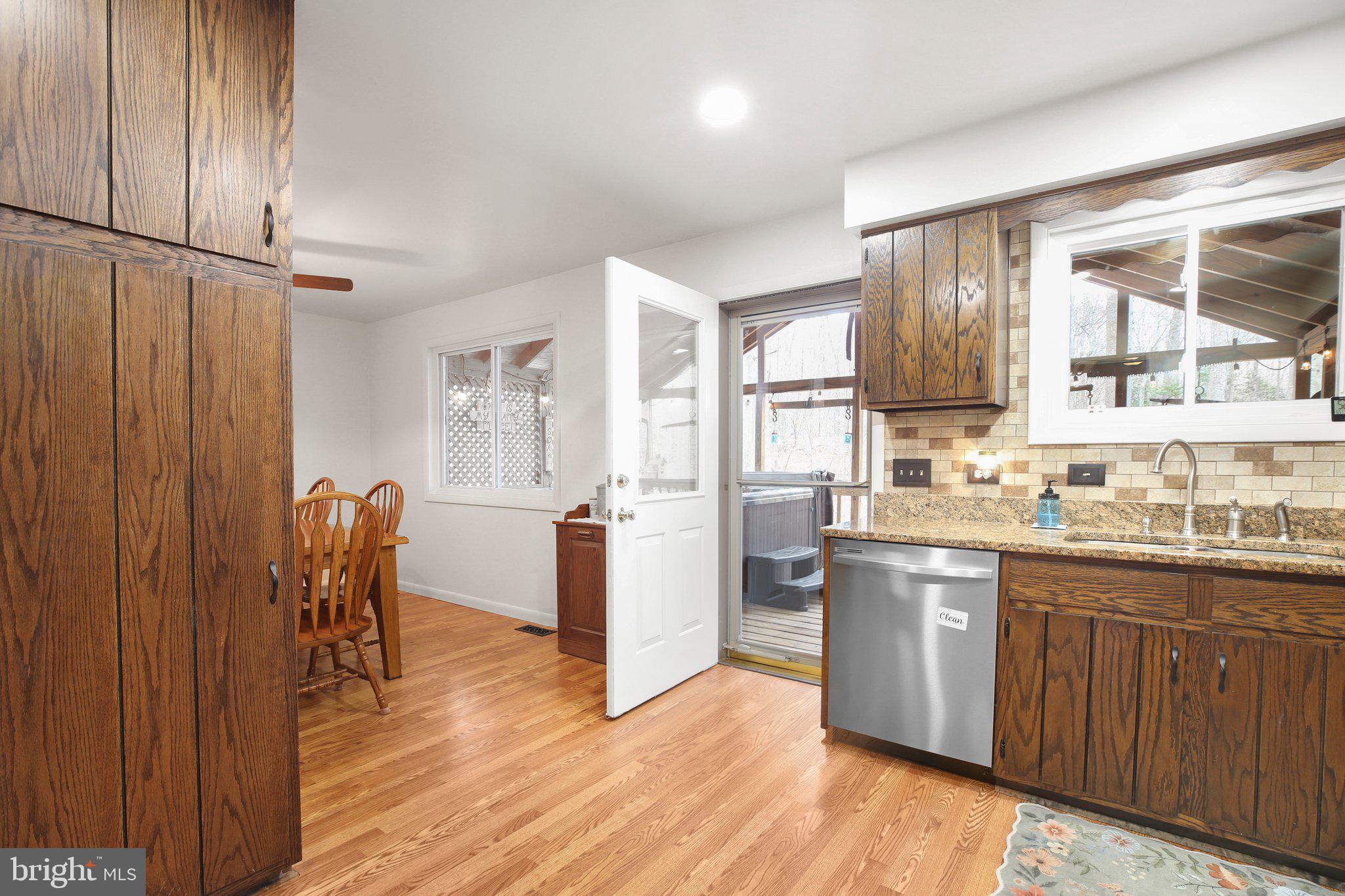 10831 Moore Drive Manassas, VA 20111 - Photo 10 of 52 a kitchen with stainless steel appliances granite countertop a refrigerator and wooden cabinets