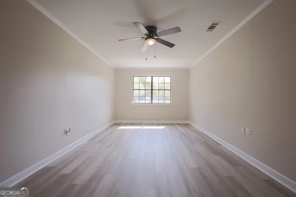a view of room with window and ceiling fan